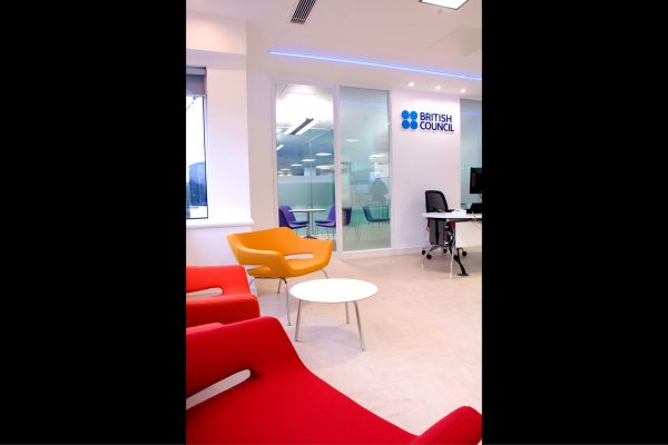 A view of the main British Council Wales reception, with colourful furniture and directional lighting